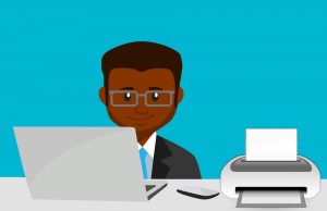 Cartoonish illustration of a man sitting in front of a laptop and a computer. Learn how to print a PDF online. 